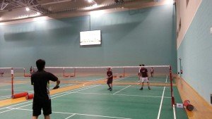 Early birds playing badminton as warm up